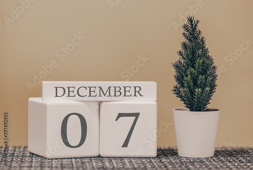 Desk calendar for use in different ideas. Winter month - December and the number on the cubes 07. Calendar of holidays on a beige solid background. photo