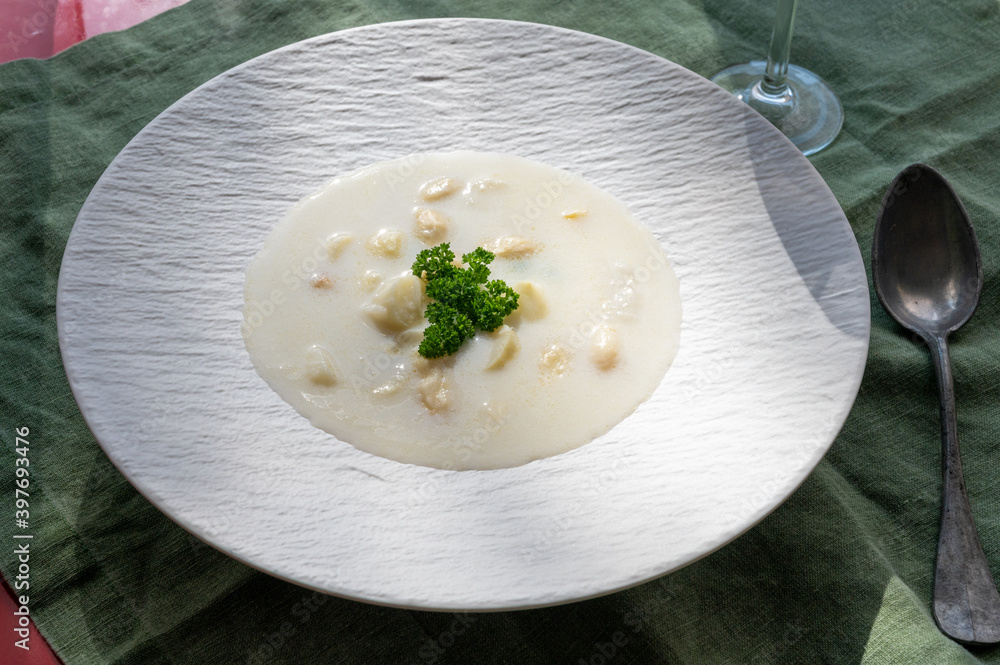 Homemade fresh seasonal white asparagus cream soup in sun lights Homemade fresh seasonal white asparagus cream soup in sun lights