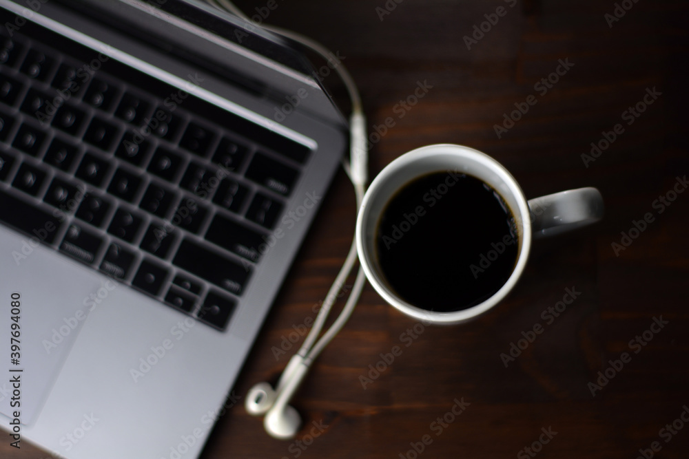 Cup of coffee and notebook on a wooden office table Cup of coffee and notebook on a wooden office table