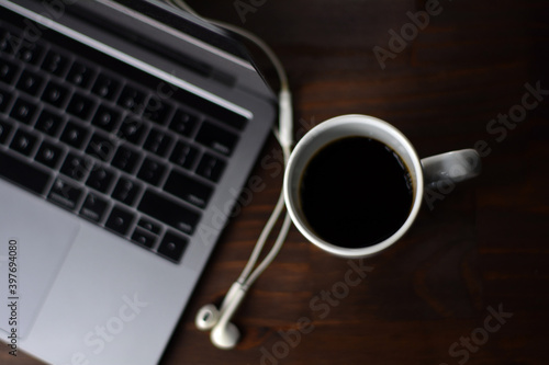 Cup of coffee and notebook on a wooden office table