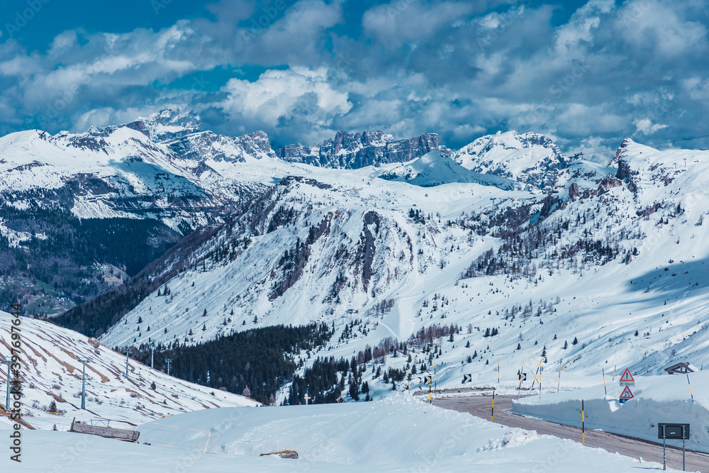 snowy white mountains with cloudy sky