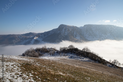 amazing winter landscape with fog and frosty trees in Romania