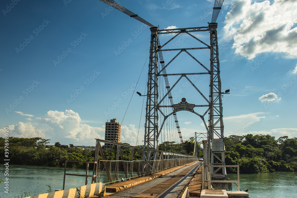 Affonso Pena steel bridge spanning the Paranaíba River, connecting Araporã, Minas Gerais, and Itumbiara, Goiás, Brazil. A stunning engineering structure in a scenic rural landscape Affonso Pena steel bridge spanning the Paranaíba River, connecting Araporã, Minas Gerais, and Itumbiara, Goiás, Brazil. A stunning engineering structure in a scenic rural landscape