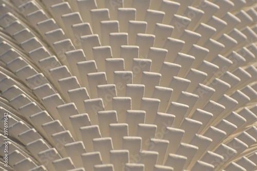 Pattern of white vanes on a heat dissipator or radiator. Part of utilities for a  northern town. photo