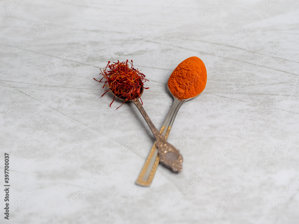 Saffron spice powder on spoons. Place for text. view from above. Food or cooking concept, bright background Saffron spice powder on spoons. Place for text. view from above. Food or cooking concept, bright background
