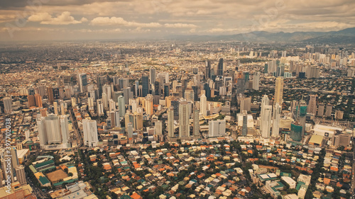 Skyscrapers at urban cityscape. Highway top down aerial view. Sun streets with roads at houses, cottages. Traffic roadway. Urbanized town of Manila, Philippine capital lifestyle. cinema birds-eye shot