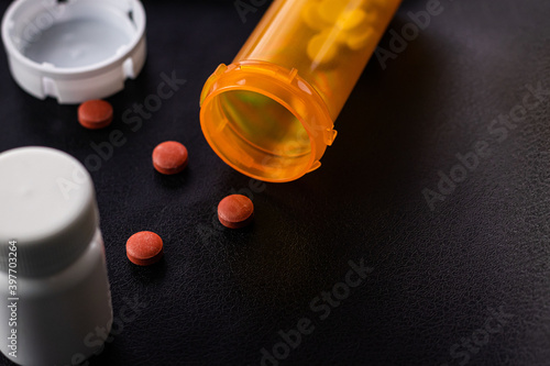 Prescription Bottle and Pills on a Black Background