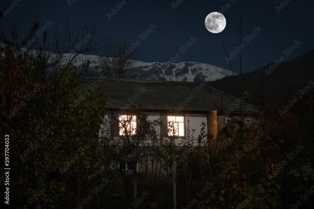 Mountain night landscape of building at forest at night with moon or vintage country house at night with clouds and stars. Summer night. Mountain night landscape of building at forest at night with moon or vintage country house at night with clouds and stars. Summer night.