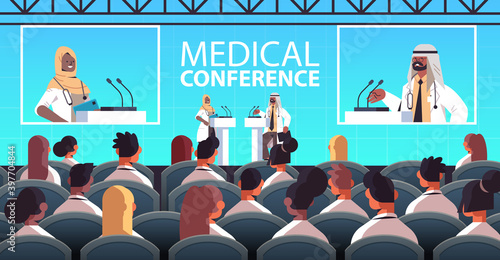 arabic doctors couple giving speech at tribune with microphone medical conference meeting medicine healthcare concept lecture hall interior horizontal vector illustration