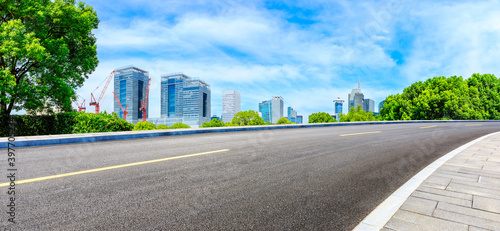 Empty asphalt road and Shanghai skyline with buildings scenery.