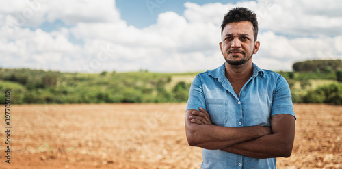 latin american farmer with arms crossed looking to the right