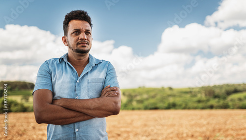 latin american farmer with arms crossed looking to the right