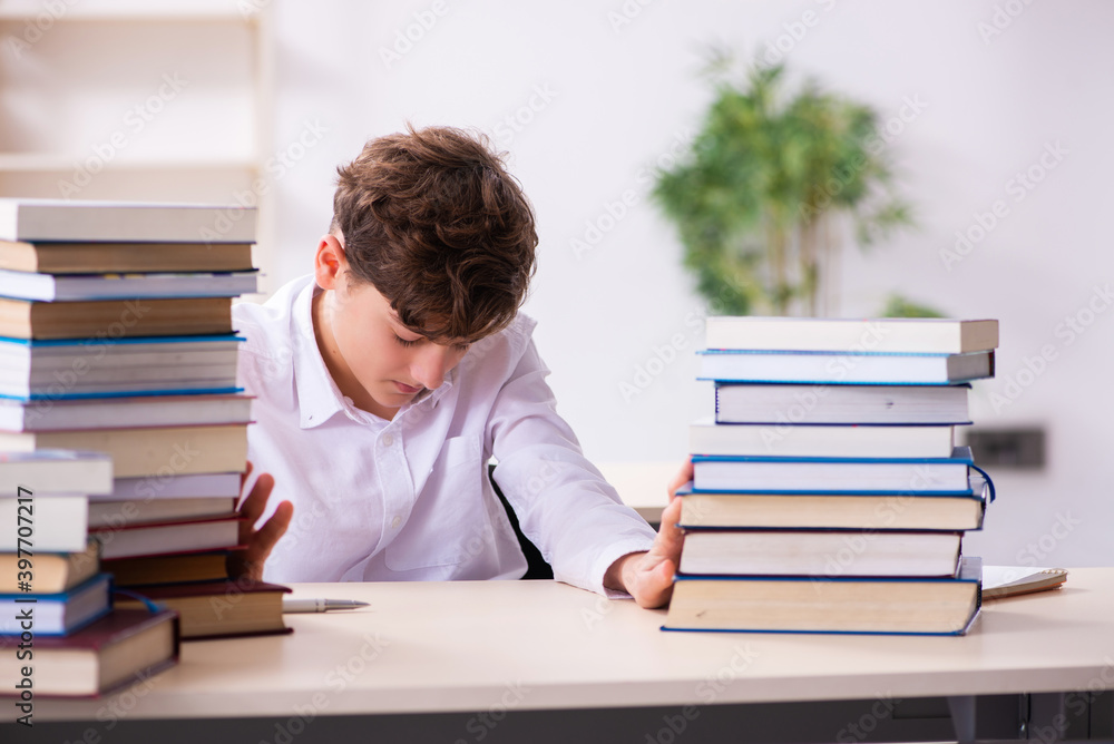 Schoolboy preparing for exams in the classroom Schoolboy preparing for exams in the classroom