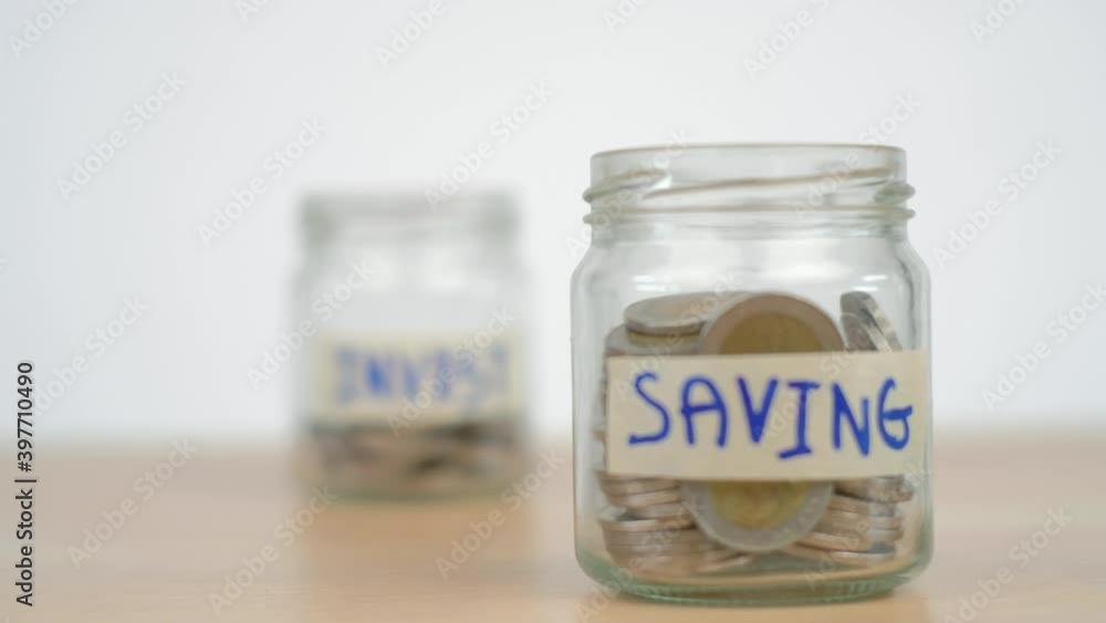 Saving growth money and investment concept, coin or money in glass jar on wooden desk. Slider shot. Saving growth money and investment concept, coin or money in glass jar on wooden desk. Slider shot.
