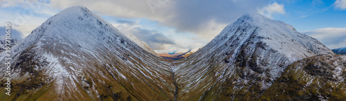 aerial view of glen etive in winter near rannoch moor in the argyll region of the highlands of scotland showing snow dusting on the mountains and munros photo