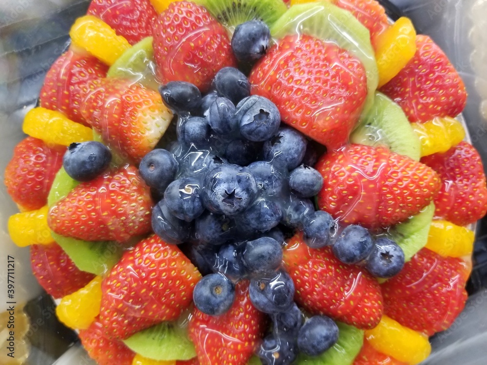 Fruit cakes decorated with blueberries, strawberries, kiwi and peach Fruit cakes decorated with blueberries, strawberries, kiwi and peach