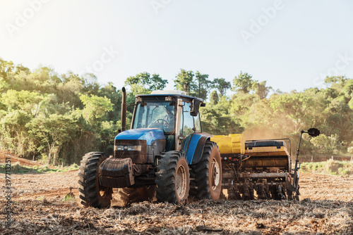 Farmer drives a tractor on a sunny summer day