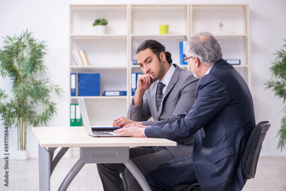 Old and young businessmen in business meeting concept Old and young businessmen in business meeting concept