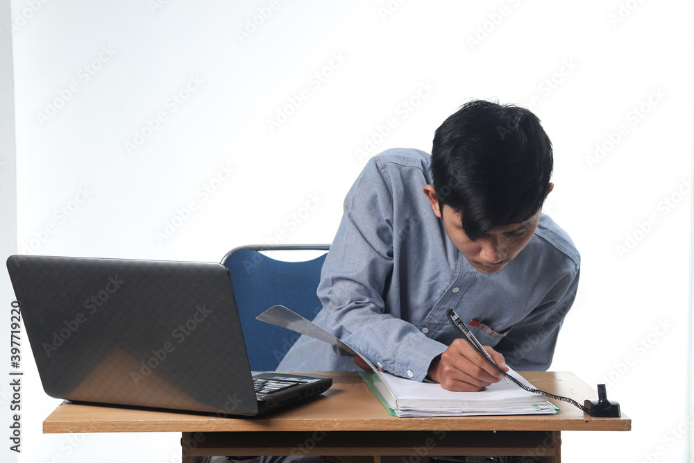 portraits of Asian men seriously working on reports on computers and notebooks. office employee bustling concept with isolated white background portraits of Asian men seriously working on reports on computers and notebooks. office employee bustling concept with isolated white background