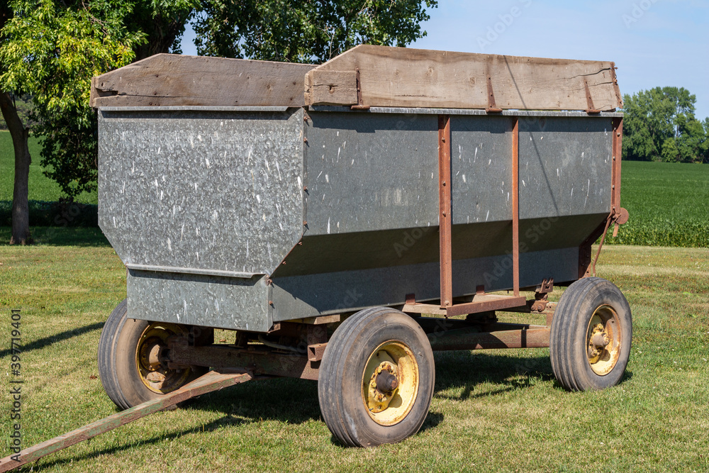 Fototapeta premium Close up abstract view of a vintage tractor or truck drawn grain wagon trailer farm implement, used for hauling harvested grain