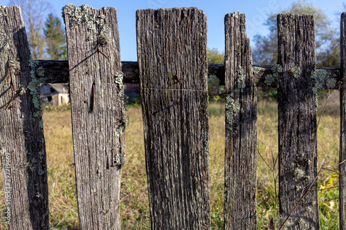 Old wooden fence on a ranch on a Sunny autumn day.