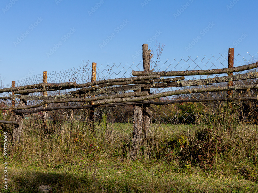 Old wooden fence on a ranch on a Sunny autumn day. Old wooden fence on a ranch on a Sunny autumn day.