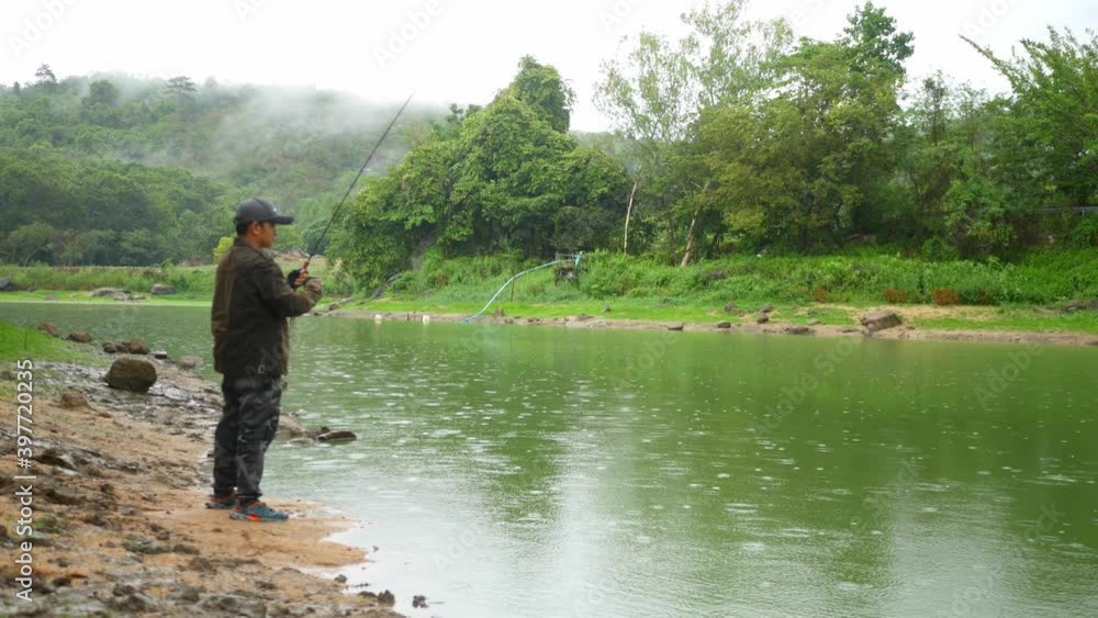 A man fishing in a large lagoon, weekend leisure activity. A man fishing in a large lagoon, weekend leisure activity.