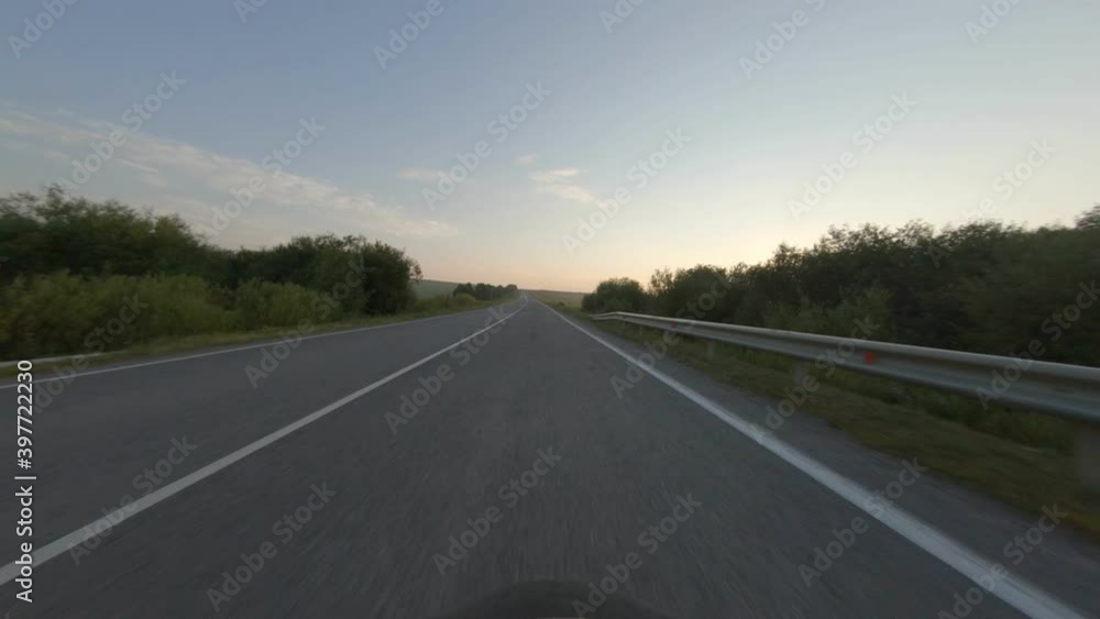 Traffic on highway. View from a car driving down a road. Russian nature on sunrise. Traffic on highway. View from a car driving down a road. Russian nature on sunrise.