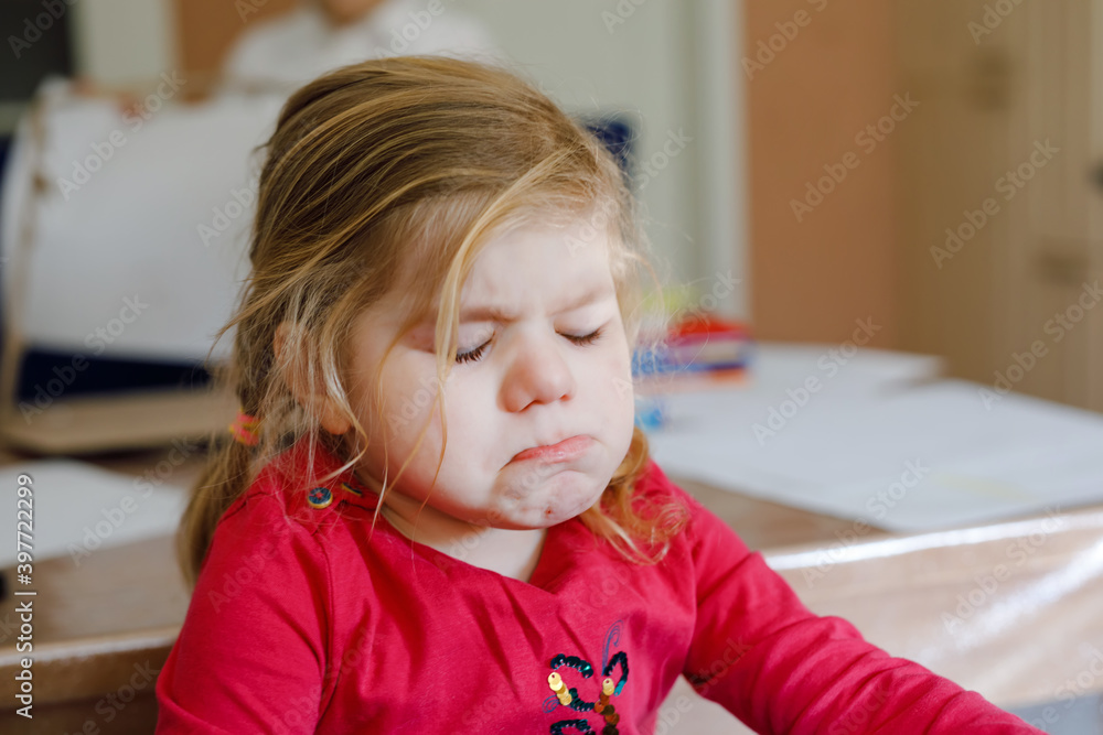 Fototapeta premium Cute upset unhappy toddler girl crying. Angry emotional child shouting. Portrait of kid with tears.