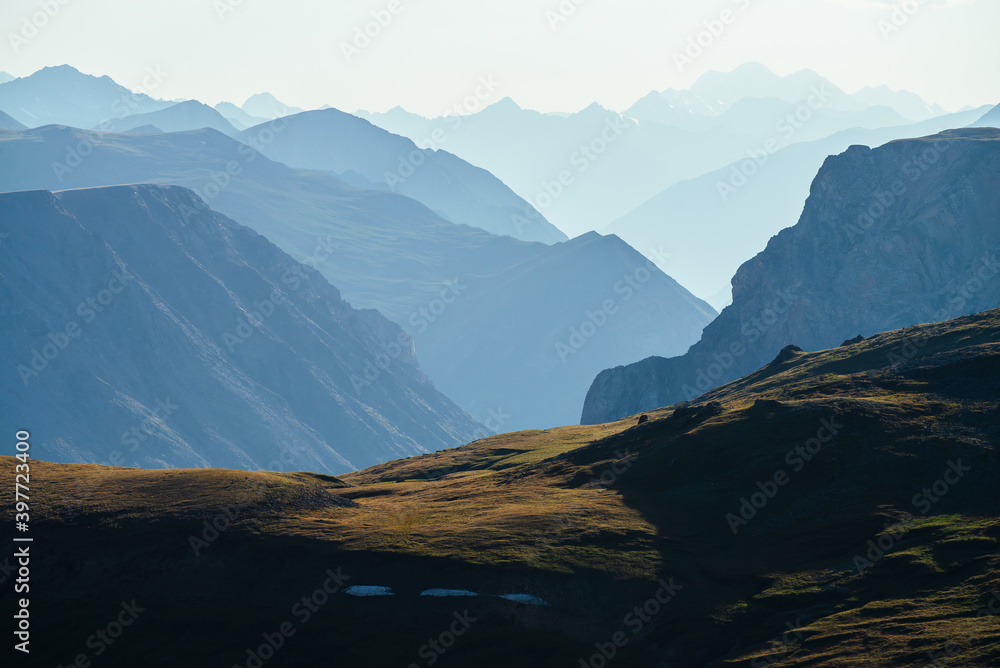 Awesome aerial view to great mountains in distance behind deep gorge. Scenic mountain landscape with giant rockies and deep abyss. Wonderful highland scenery with huge cliff. Big rocks and precipice.