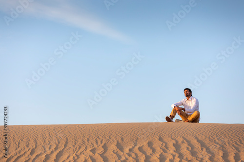 Photography a man in a desert at surise