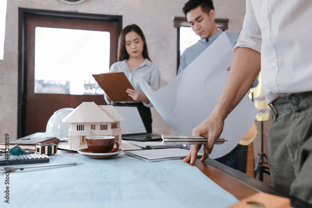 Fototapeta premium industry manager and engineer, businessman reading and checking blueprint, drawing in the room