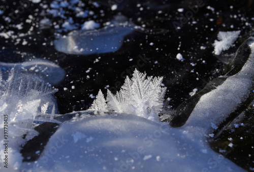 Stunning frozen icicles waterfall on a rocky mountain cliff on a winter day. The winter cascade is frozen in numerous white icicles. Waterfall falling past hundreds of icicles fantastic winter landsca