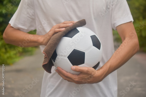 Hand holding Wiping cloth cleaning football