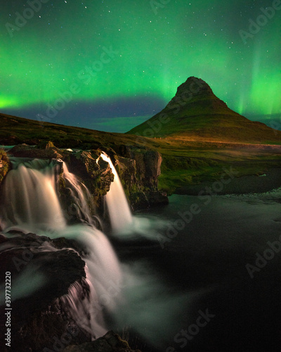 Beautiful aurora dancing over Kirkjufell mountain in Iceland, image noise due high ISO