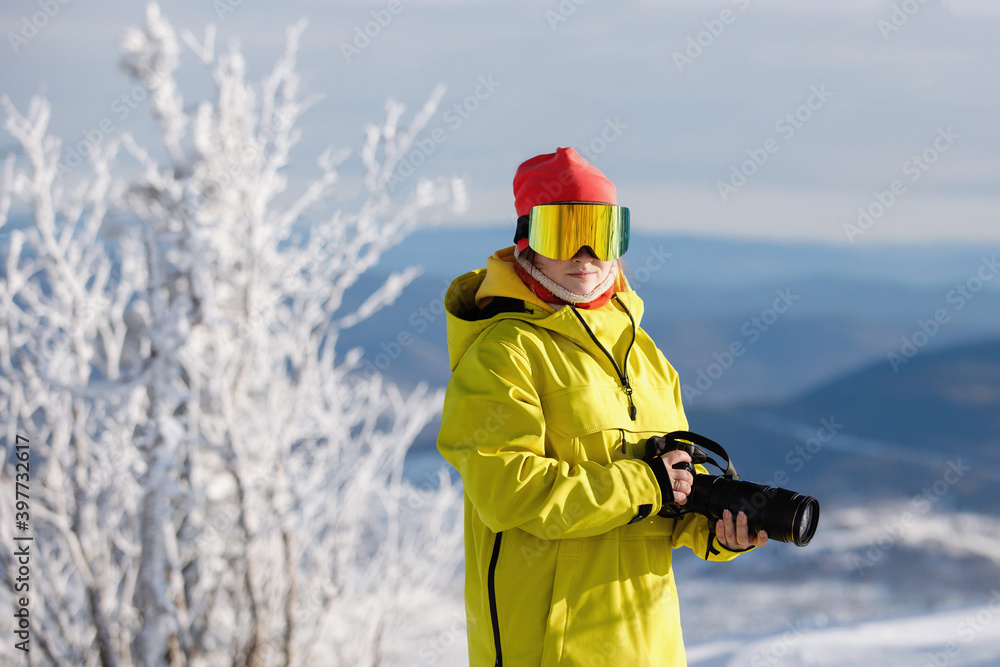 Photographer in the open air in winter ski clothes