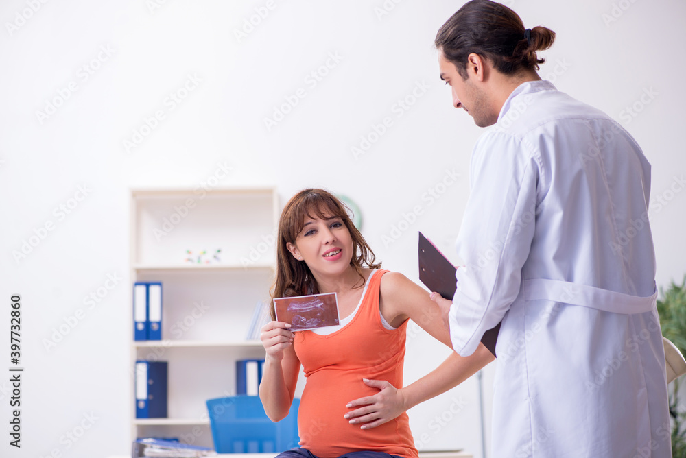 Pregnant woman visiting male doctor gynecologist Pregnant woman visiting male doctor gynecologist