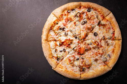 pizza with mozzarella cheese, ham, vegetables and pepperoni, top view
