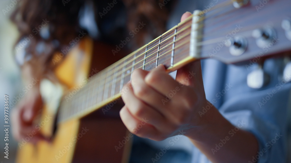 Girl hands playing guitar. Female musician creating music with string instrument