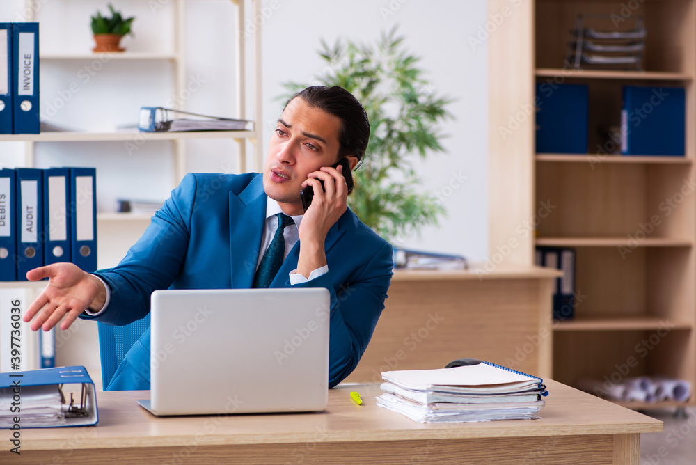 Young handsome employee sitting in the office Young handsome employee sitting in the office