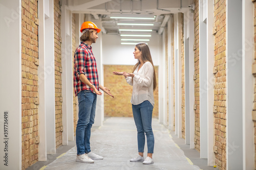 Female purchaser discussing construction issues with the worker