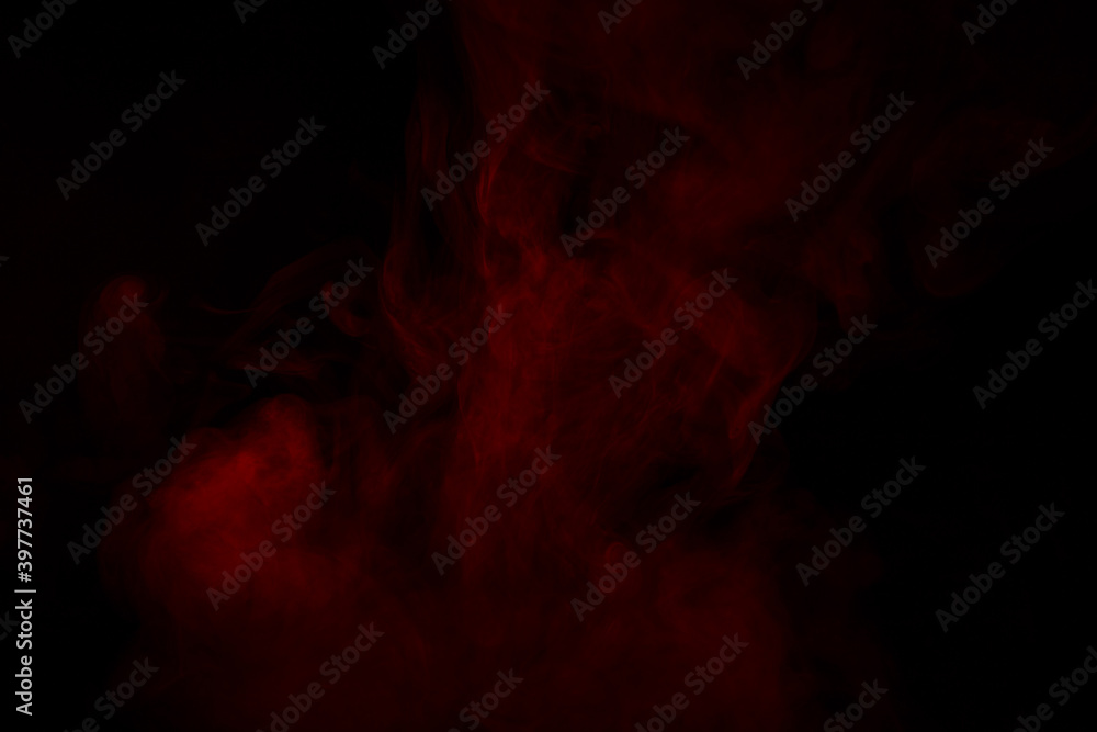 Fototapeta premium Colorful smoke close-up on a black background. Red cloud of smoke.