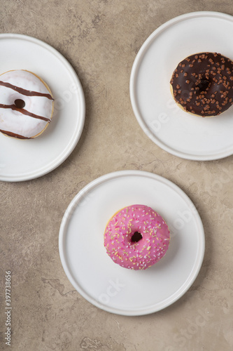colorful donuts on rustic textured background