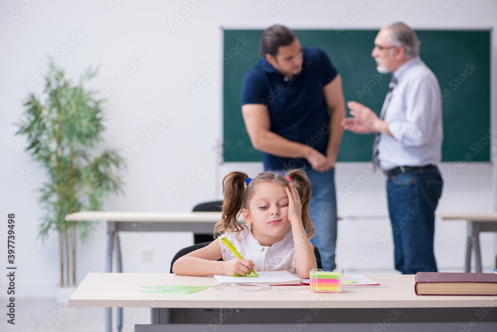 Obraz premium Young parent, old male teacher and little girl in the classroom