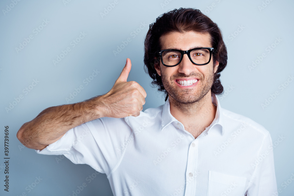 Photo portrait of smiling positive man showing thumb up isolated on clear white colored background Photo portrait of smiling positive man showing thumb up isolated on clear white colored background