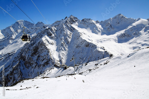 Skiers on the Elbrus mountain track and the Krugozor station of the gondola cable car, Elbrus region, Caucasus