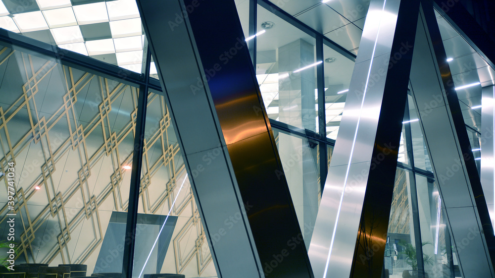 Obraz premium Pattern of office buildings windows illuminated at night. Lighting with Glass architecture facade design with reflection in urban city.