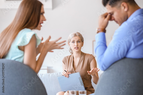 Psychologist working with young couple in office