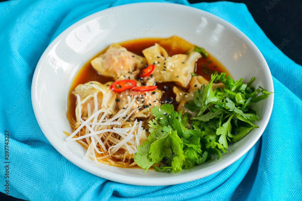 Boiled meat dumplings with fresh parsley, soy sauce and sesame seeds. Delicious meal for dinner. Boiled meat dumplings with fresh parsley, soy sauce and sesame seeds. Delicious meal for dinner.