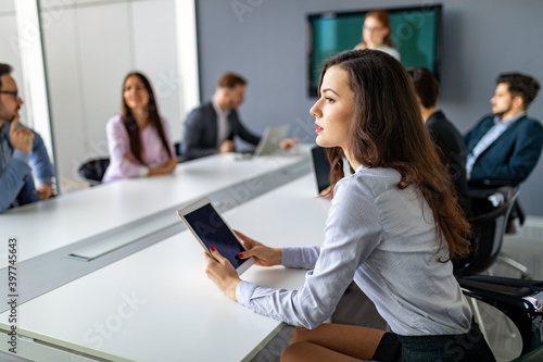 Business people having board meeting in modern office © NDABCREATIVITY